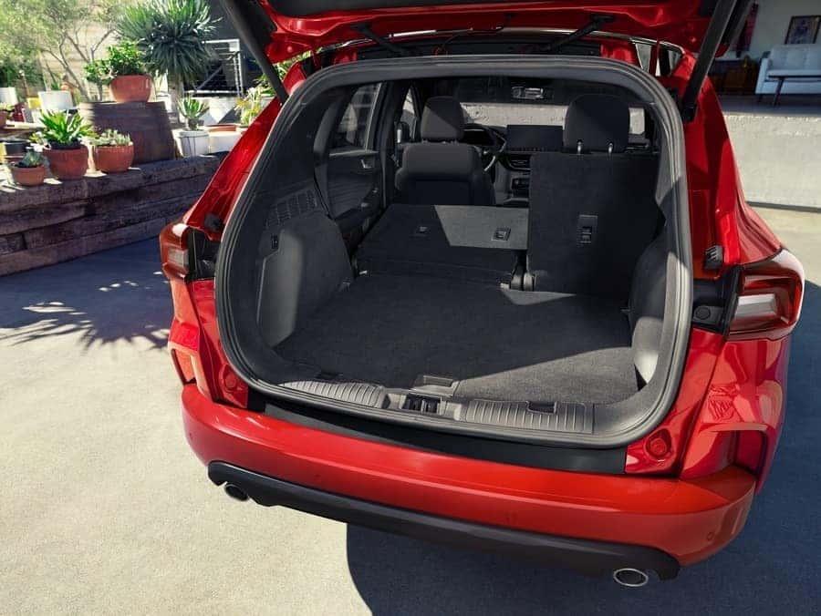Red Ford Escape with Open Trunk in Driveway